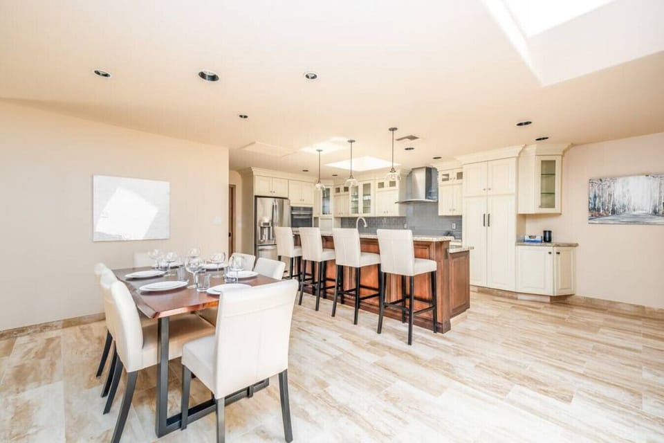 Bright kitchen with breakfast bar, granite countertops, and seamless flow for entertaining.