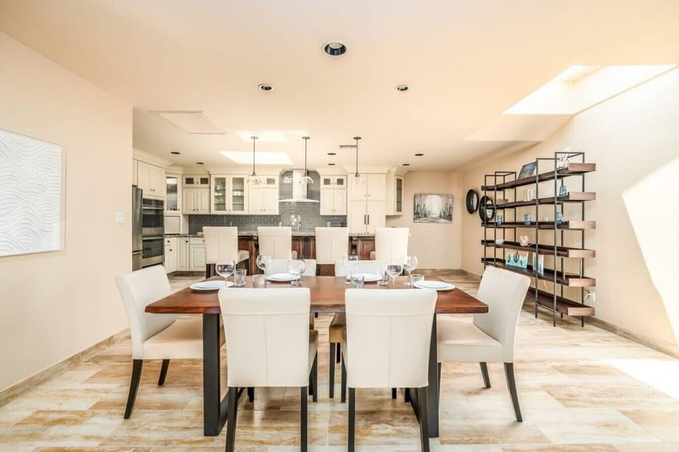 Elegant dining area with seating for six, open to a spacious chef’s kitchen.