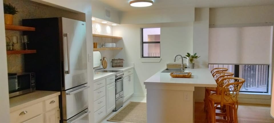 Kitchen and beverage center with electric stove purified water washer dryer dishwasher ice maker microwave and Keurig coffee maker