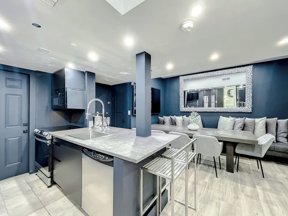 Full-size kitchen with brand new state-of-art Samsung stove, convection oven, air fryer, island bar with in-kitchen dining, entertaining 70-inch smart TV in the dining room, 50-inch in kitchen, stone dining table for up to 12 persons & bar seating.