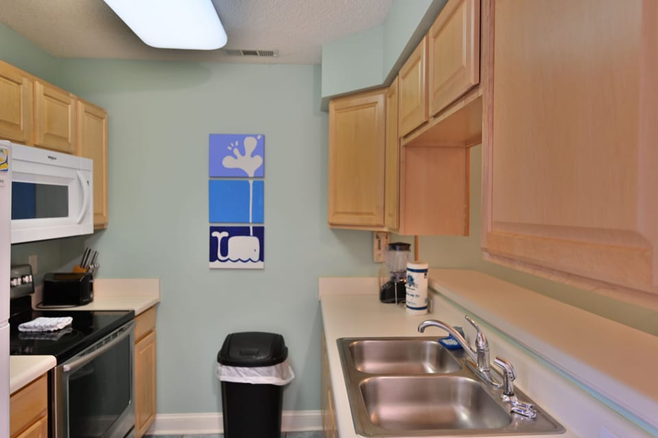 Kitchen with double sink, wood cabinets, and modern layout