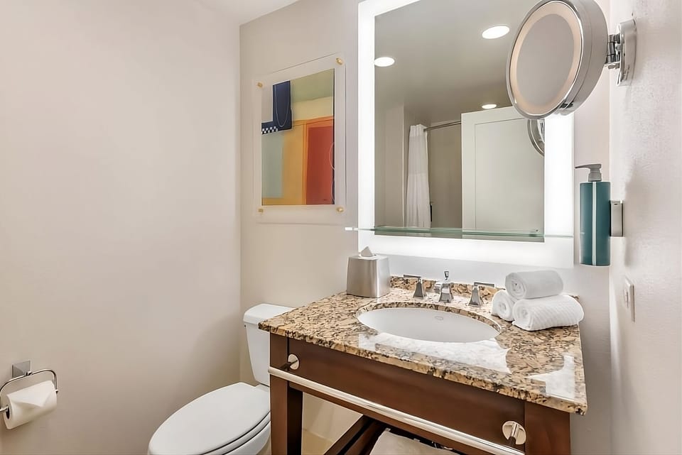 Get ready effortlessly with a sleek vanity and plush towels.