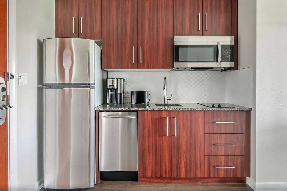 Brew morning coffee in a sleek, fully stocked kitchenette.