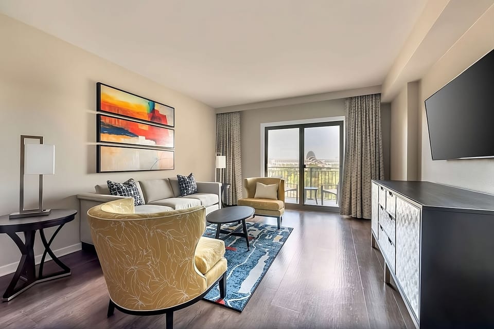 Relax with a glass of wine beside bright balcony doors.
