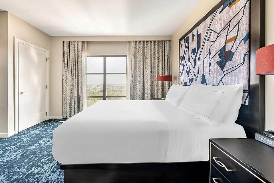 Relax under soft lighting in a spacious king bedroom.