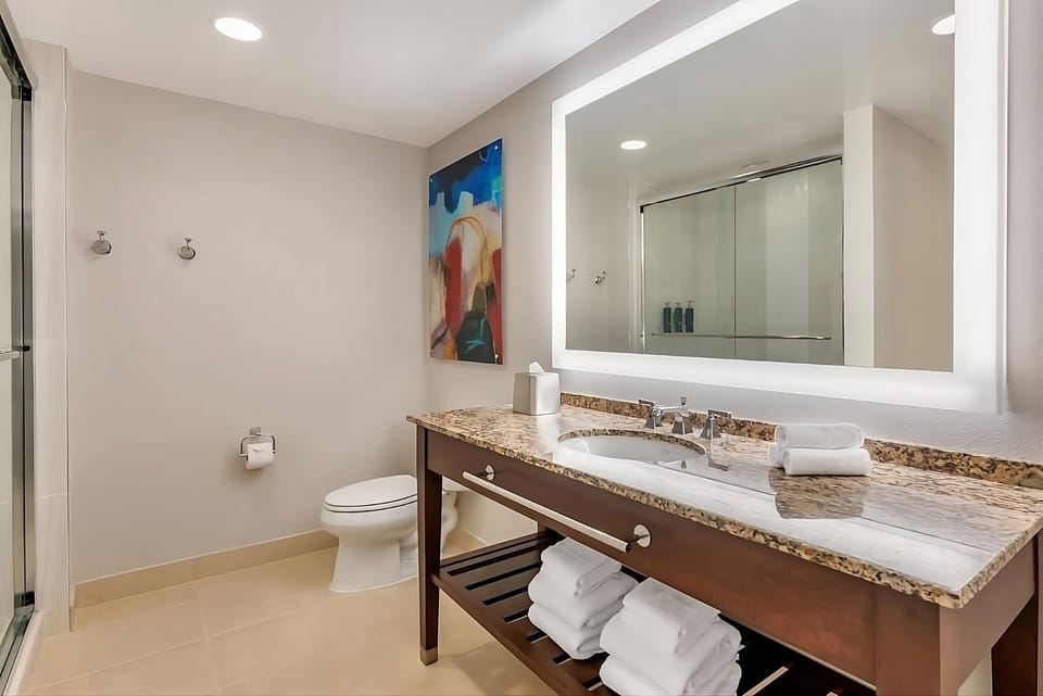 Refresh in a spotless bath with bright mirror lighting.