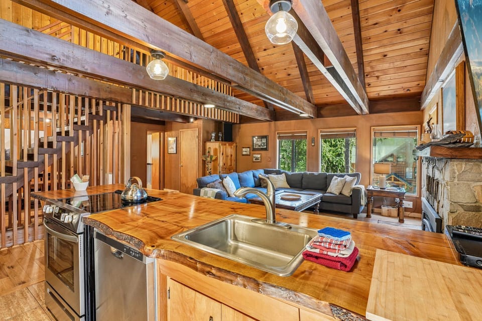 Open floorplan kitchen looks out to living room and vaulted ceiling