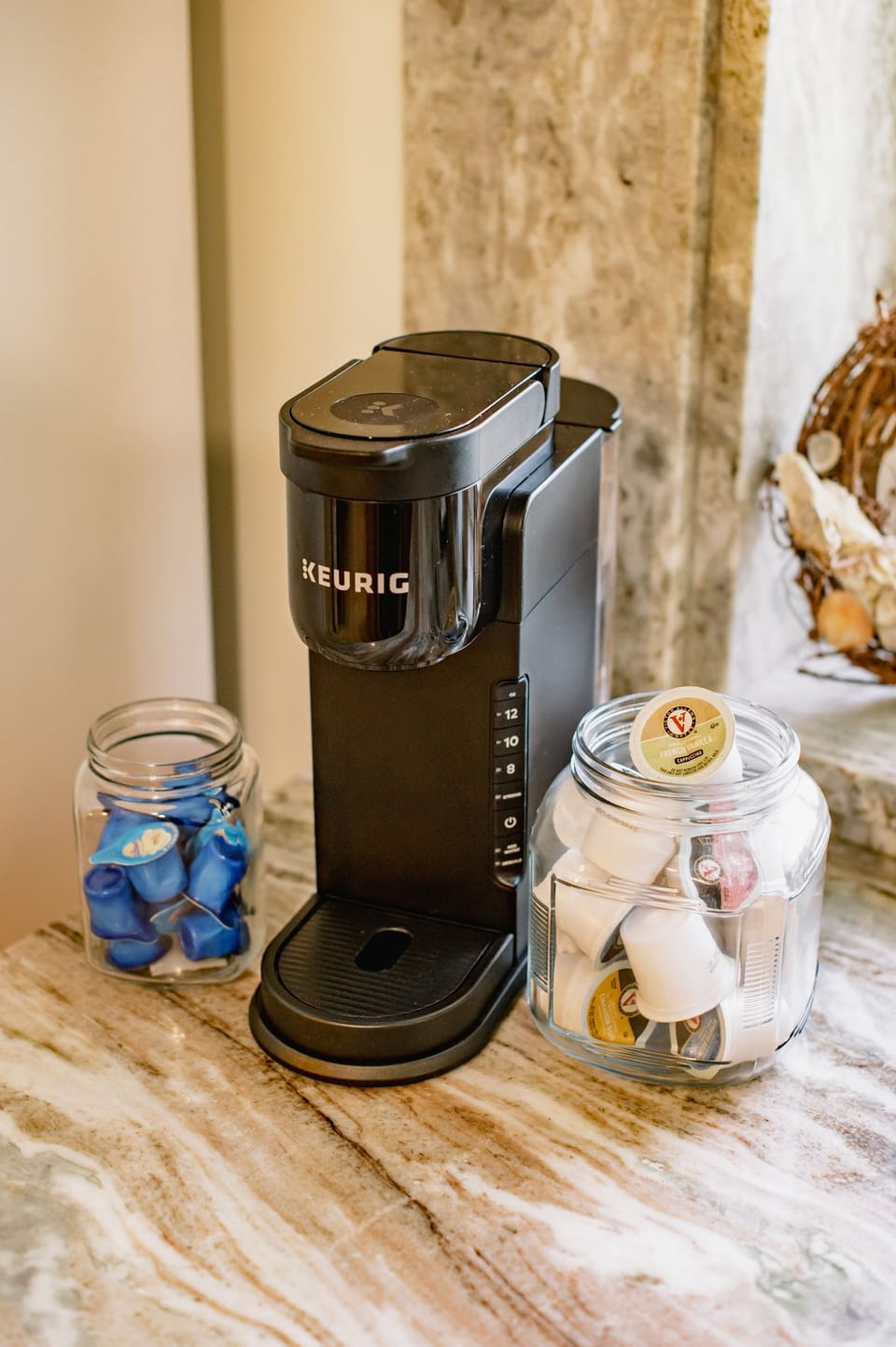 A coffee bar complete with cream, sugar, and a variety of K-Cups, offering a delightful assortment of flavors and options to satisfy every coffee lover 