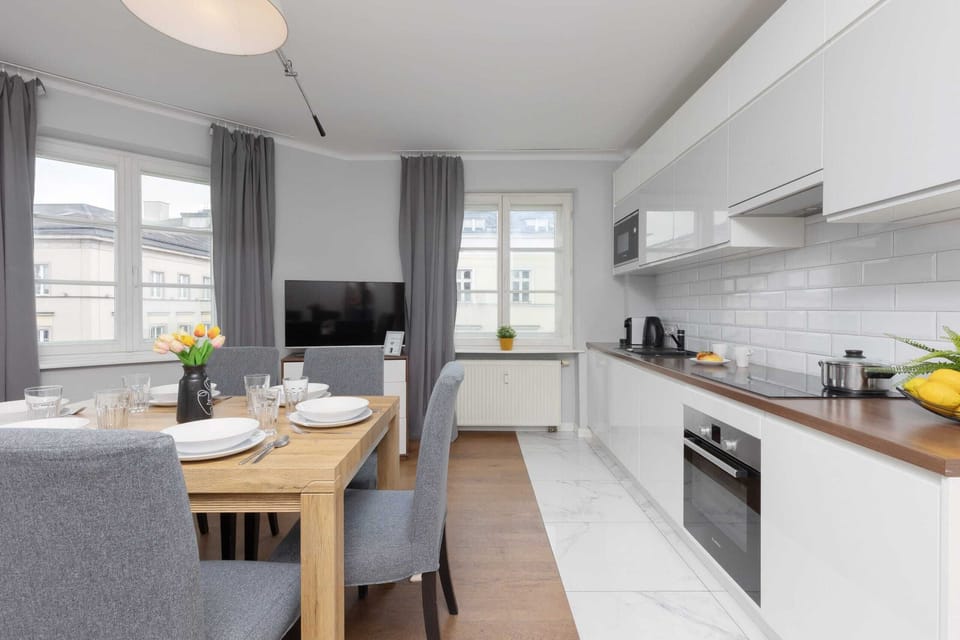 A combined dining and living area, featuring stylish gray chairs and tasteful decor.