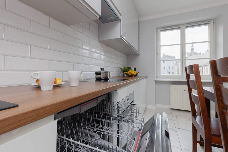 A warm and inviting dining space adjacent to the kitchen, complete with wooden furniture and a view of the outside.
