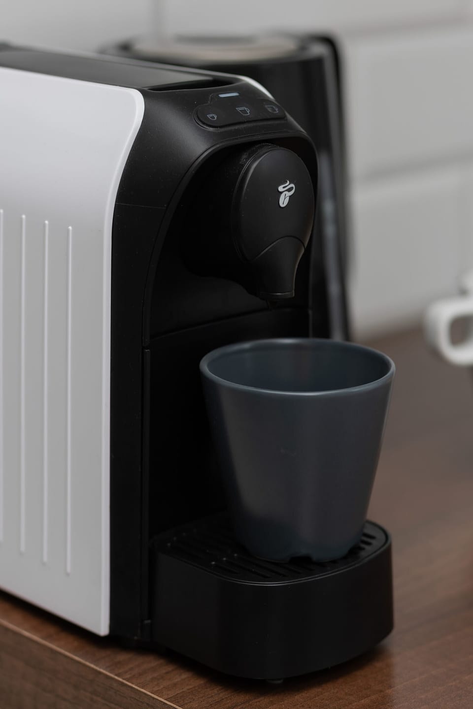 A close-up shot of a coffee machine and cups, adding a practical and cozy touch.