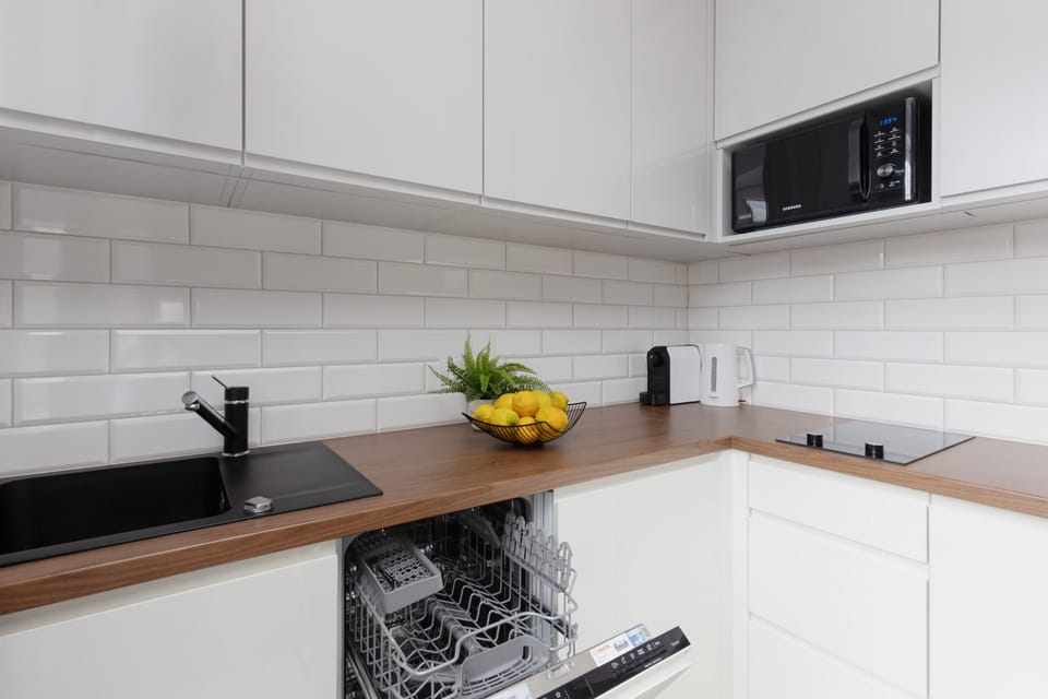 Another angle of the kitchen, showcasing its clean design and additional counter space.
