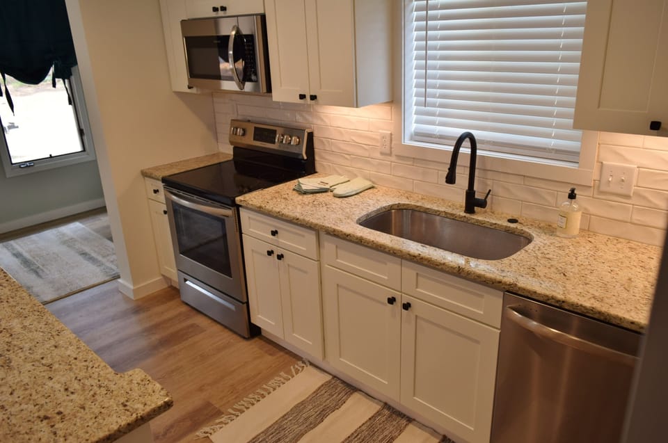 Beautiful kitchen nicely equipped with cookware, serve ware, and appliances.