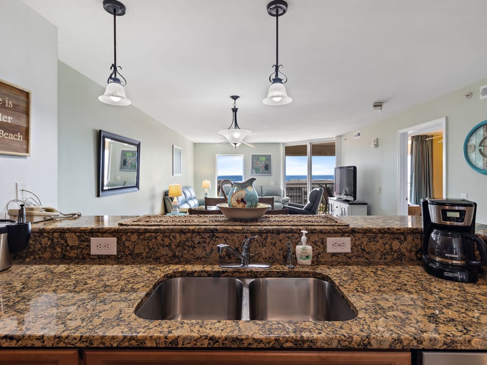 Your granite kitchen island offers stunning ocean views while you prepare meals, with modern appliances and coastal charm.