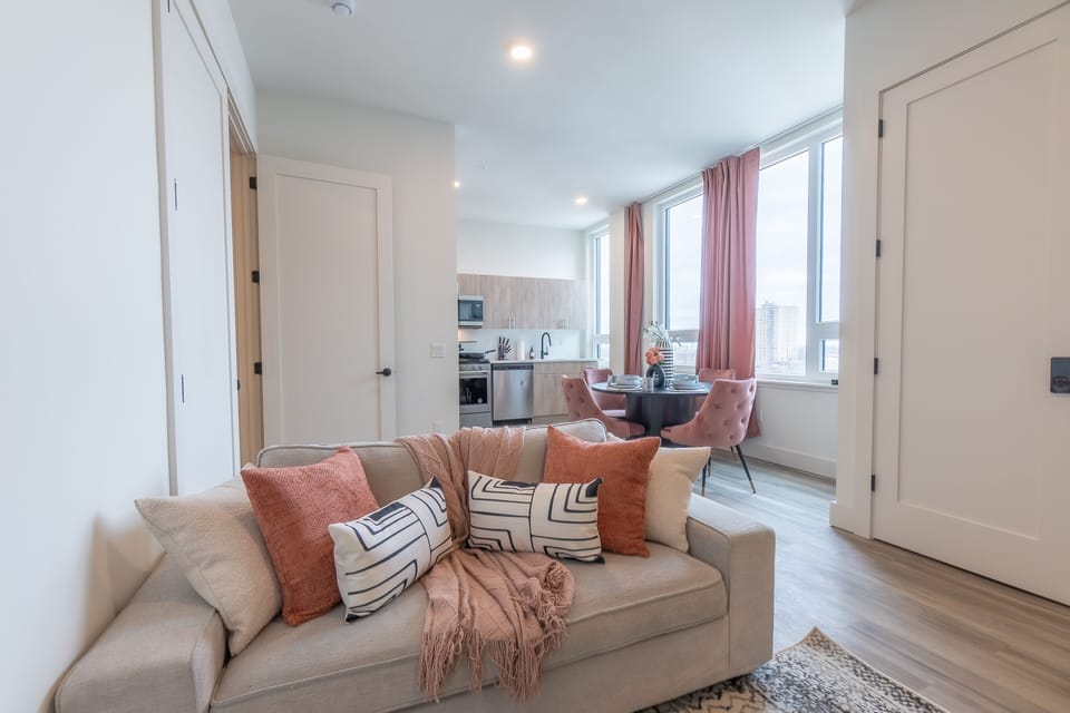 Relaxing living space with cozy sofa,smart TV, and warm decor.