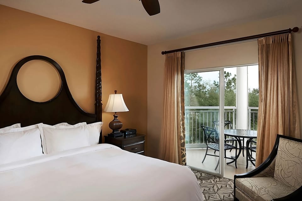 Wake up to balcony views from a serene king bed.