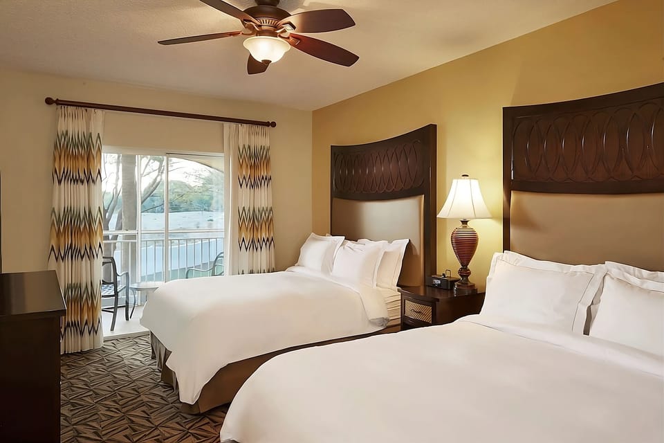 Gather comfortably with two plush beds and breezy balcony access.