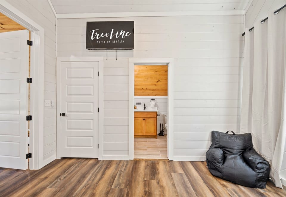 The bunk room includes easy access to a bathroom, making it convenient for everyone.