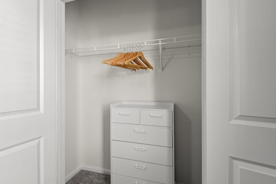 Organize your living space with sleek white storage solutions and a set of hangers