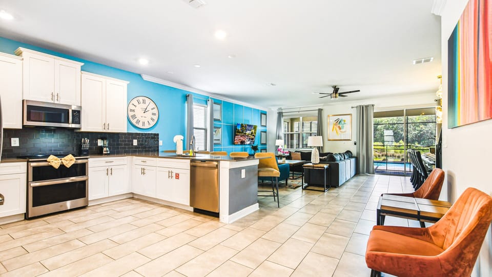 Bright, modern open-concept living! Fully equipped kitchen, cozy seating, pool view.