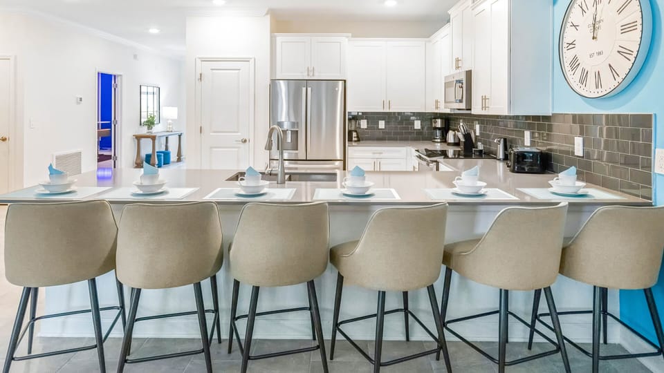 Modern kitchen with sleek island seating for 6, stainless steel appliances, and charm!