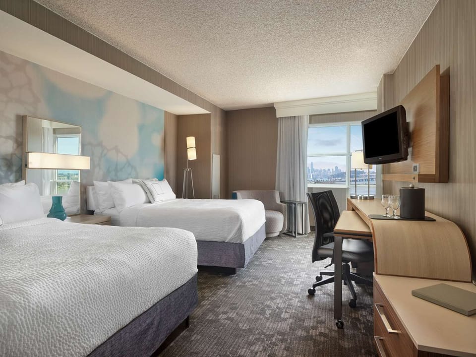 Unwind in bright double-queen comfort with skyline views.