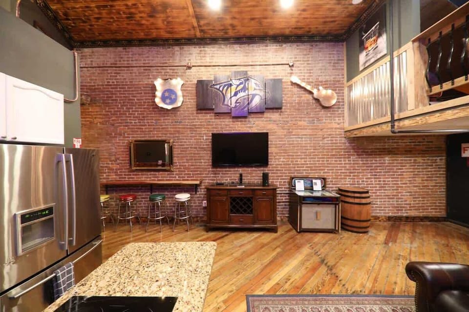 The entertainment wall: large 60" flatscreen TV, 1973 Rockola Jukebox with hand picked records and inserts.