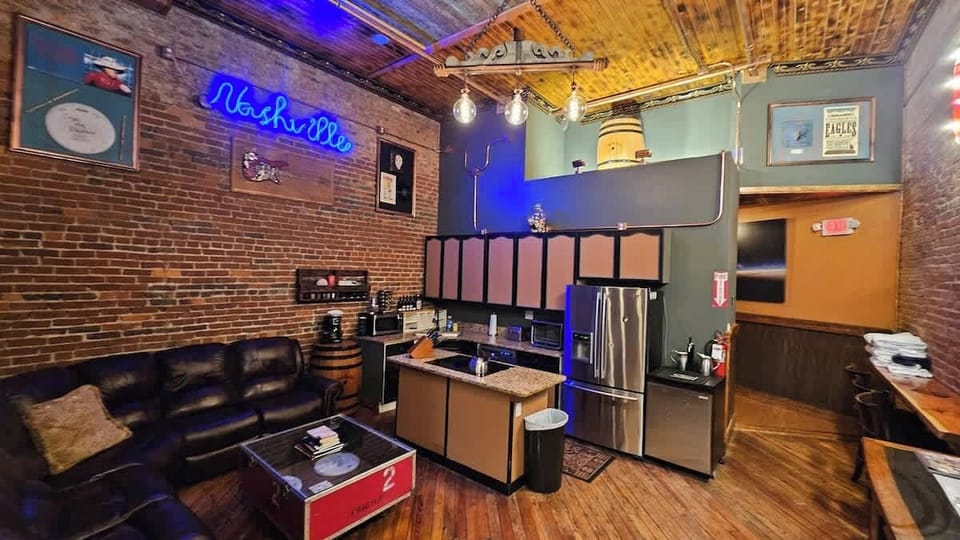 Modern kitchen featuring stainless steel appliances, Custom three-tone cabinets, ample storage space and granite countertops. Fully stocked with spices, oils and cookware for your culinary needs. Kegerator available upon request. 