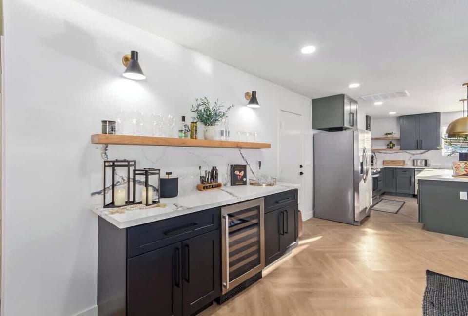 Fully stocked wall bar with cocktail accessories and wine fridge