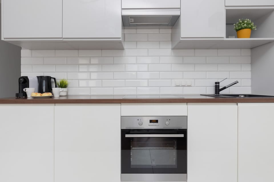 Bright kitchen with cooking utensils. 
