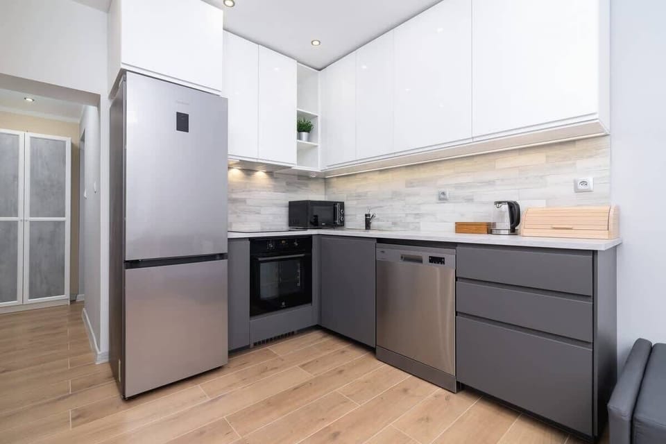 A fully equipped kitchen with stainless steel appliances and a sleek, contemporary layout.

