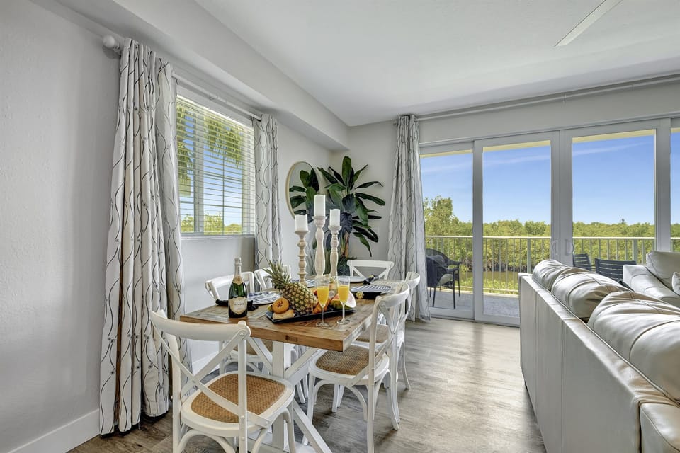 As you take a step towards this elegant expanse, your eyes are drawn to the panoramic canvas that unfolds beyond the expansive sliding doors – a view that seems to have been painted by the gentle strokes of nature's brush.