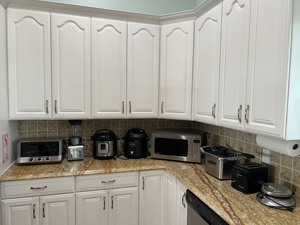 Photo showing assortment of small appliances kept under the counters.