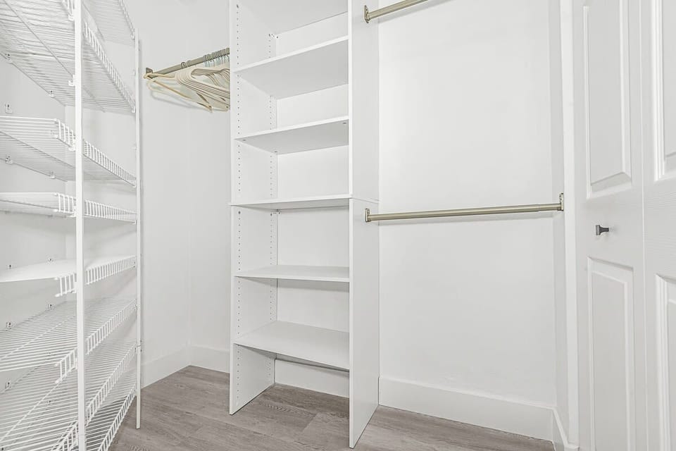 Walk in organized closet.