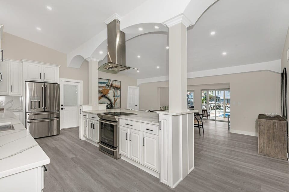 Stainless steel appliances. Open concept kitchen and living room.