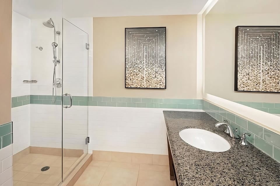 Rinse off in a sleek glass shower, hotel-fresh comfort.