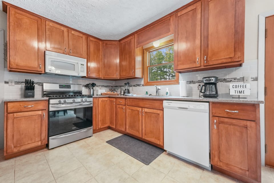 Kitchen: Cook up new memories in this bright space with modern appliances and charming decor!