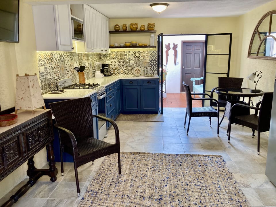 Open concept living room, kitchen, dining, with outdoor patio
