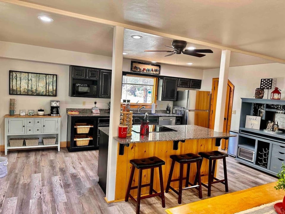 Island with stove top and fully stocked coffee bar