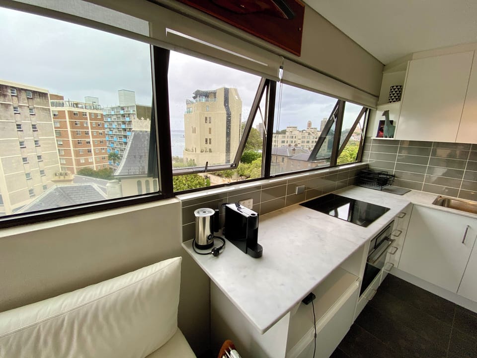 Kitchen with Carrara marble benthtop + coffee machine + oven