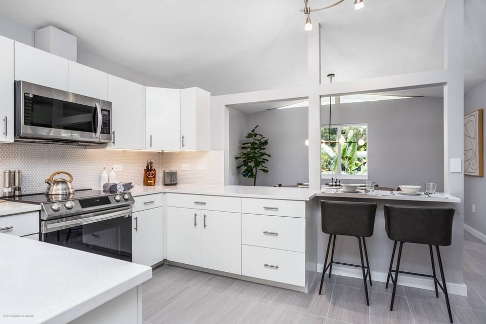Fabulous modern kitchen stocked with pots, pans and dishes to make homemade meals anytime.