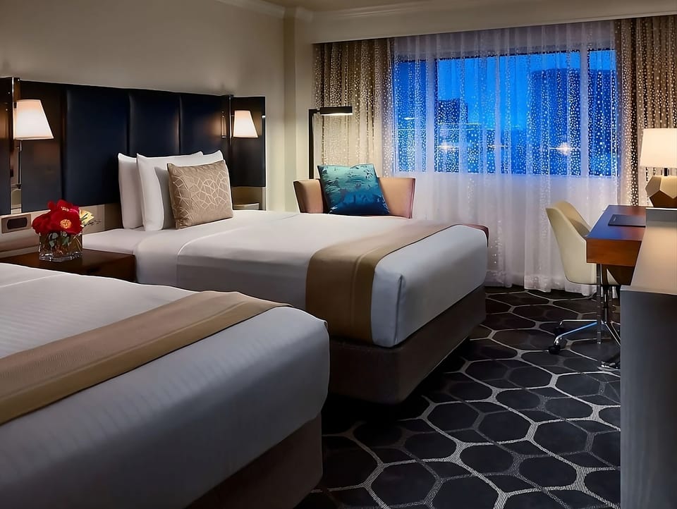 Relax into a quiet night with two comfy beds and city lights.