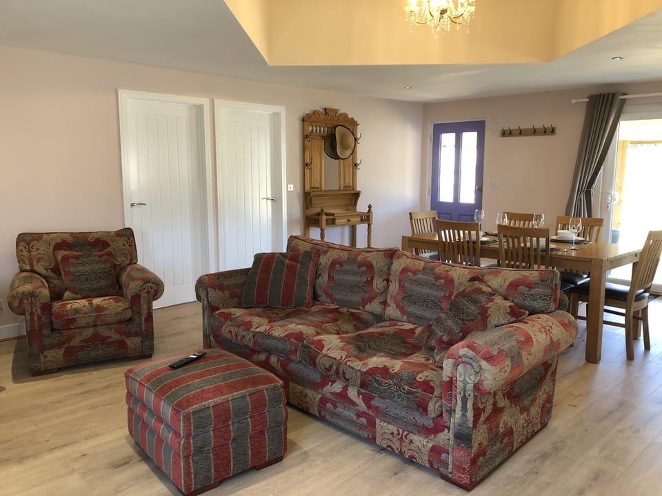 Comfy couch and 2 chairs, and large dining table comfortably seating 4 people.