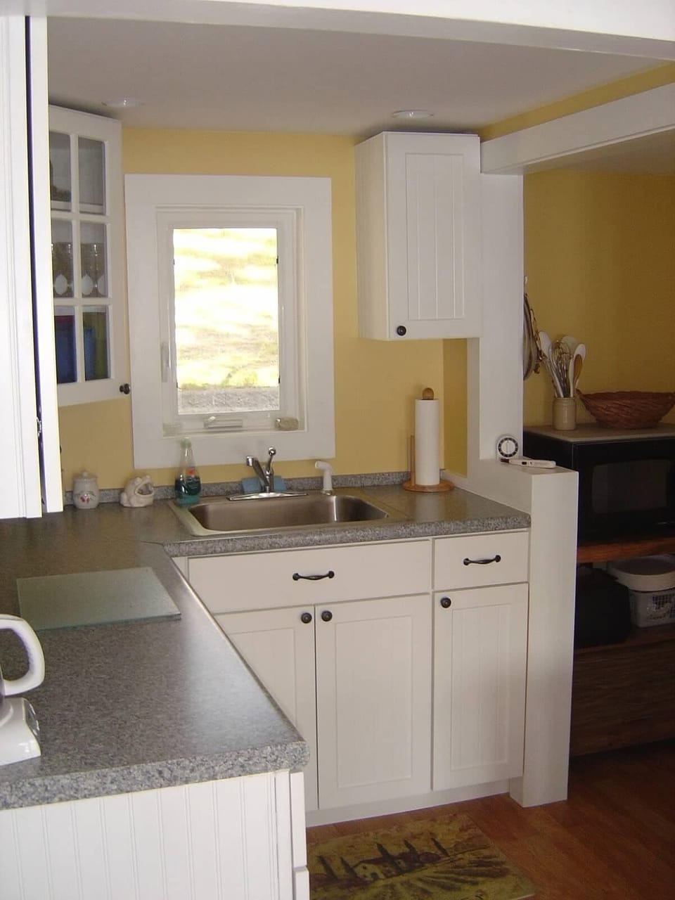 Kitchen with refrigerator, microwave, stove.