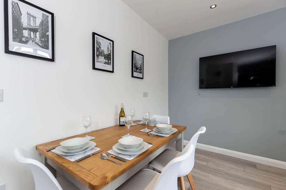 Step into a stylish dining room made for memorable meals and cosy evenings — complete with a table for four and its very own TV for dinner-and-a-show vibes