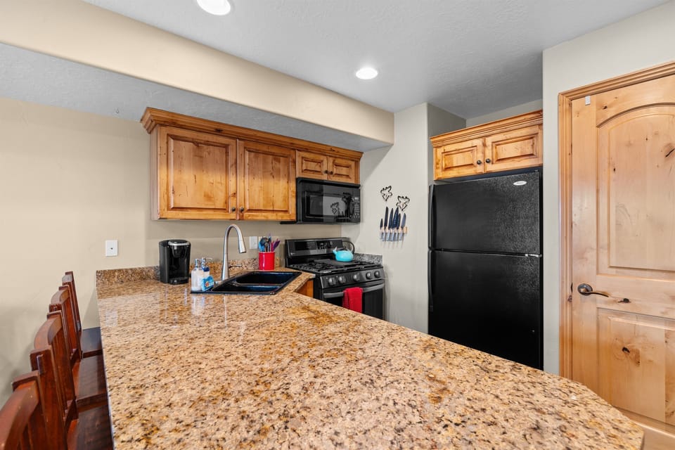 Spacious kitchen with granite countertops, full-size appliances, and plenty of prep space.