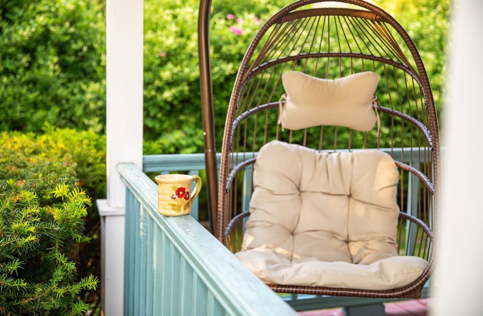 Savor slow mornings on the porch swing with coffee in hand while the garden stays quiet around you