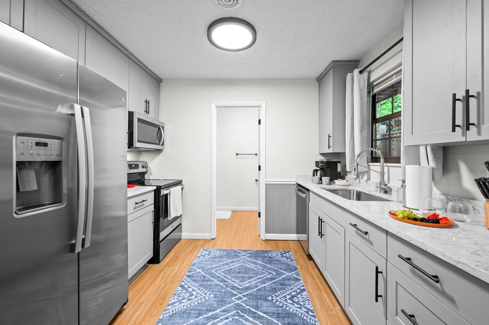 Fully stocked kitchen includes full size electric stovetop, oven, & microwave  