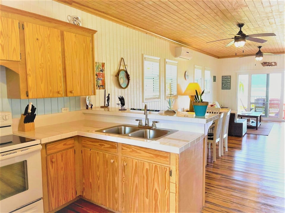 Open kitchen, dining, and living areas - all with perfect turquoise views. 