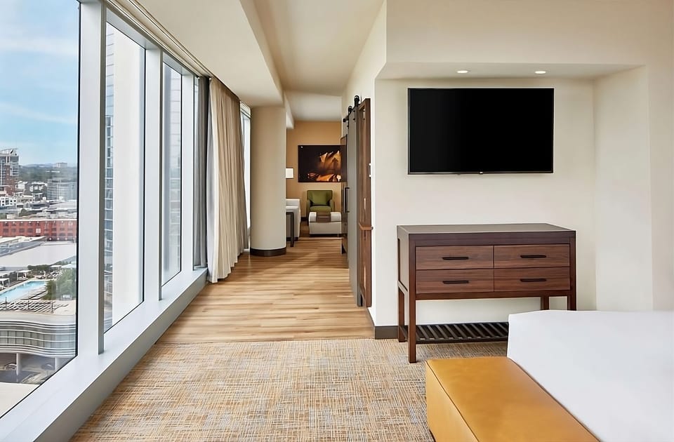 Stretch out in a spacious suite corridor framed by tall windows.